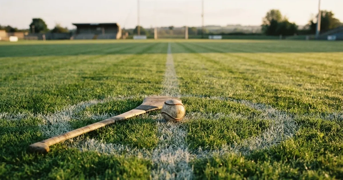 A ball on the centre spot of a grass pitch in morning light