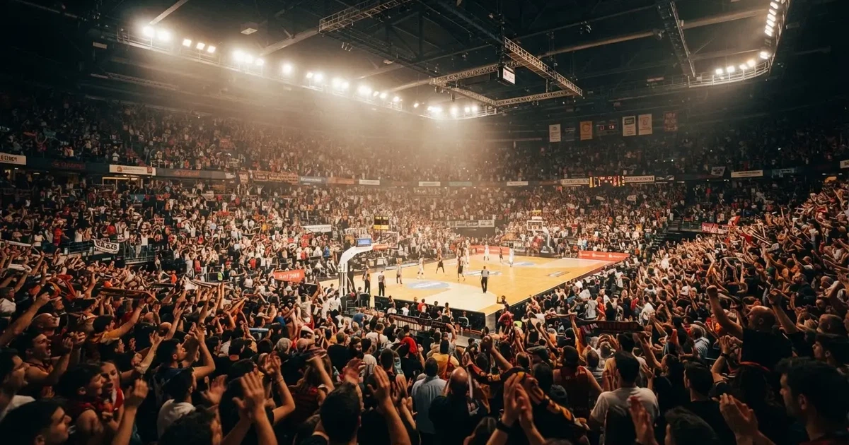A packed sports hall under floodlights photographed from a long way off
